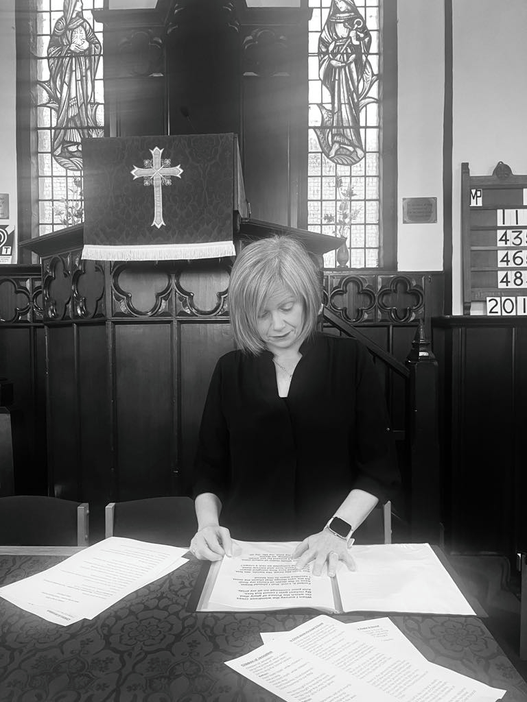 Preparing sheet music at church altar