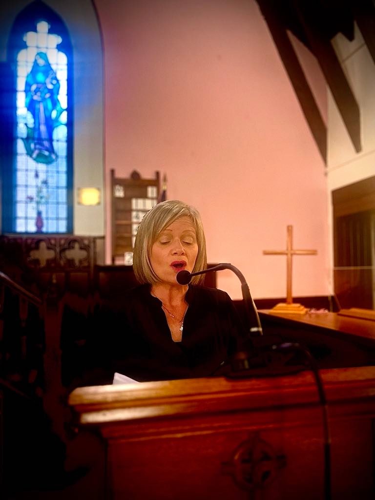 Woman singing solo at church podium